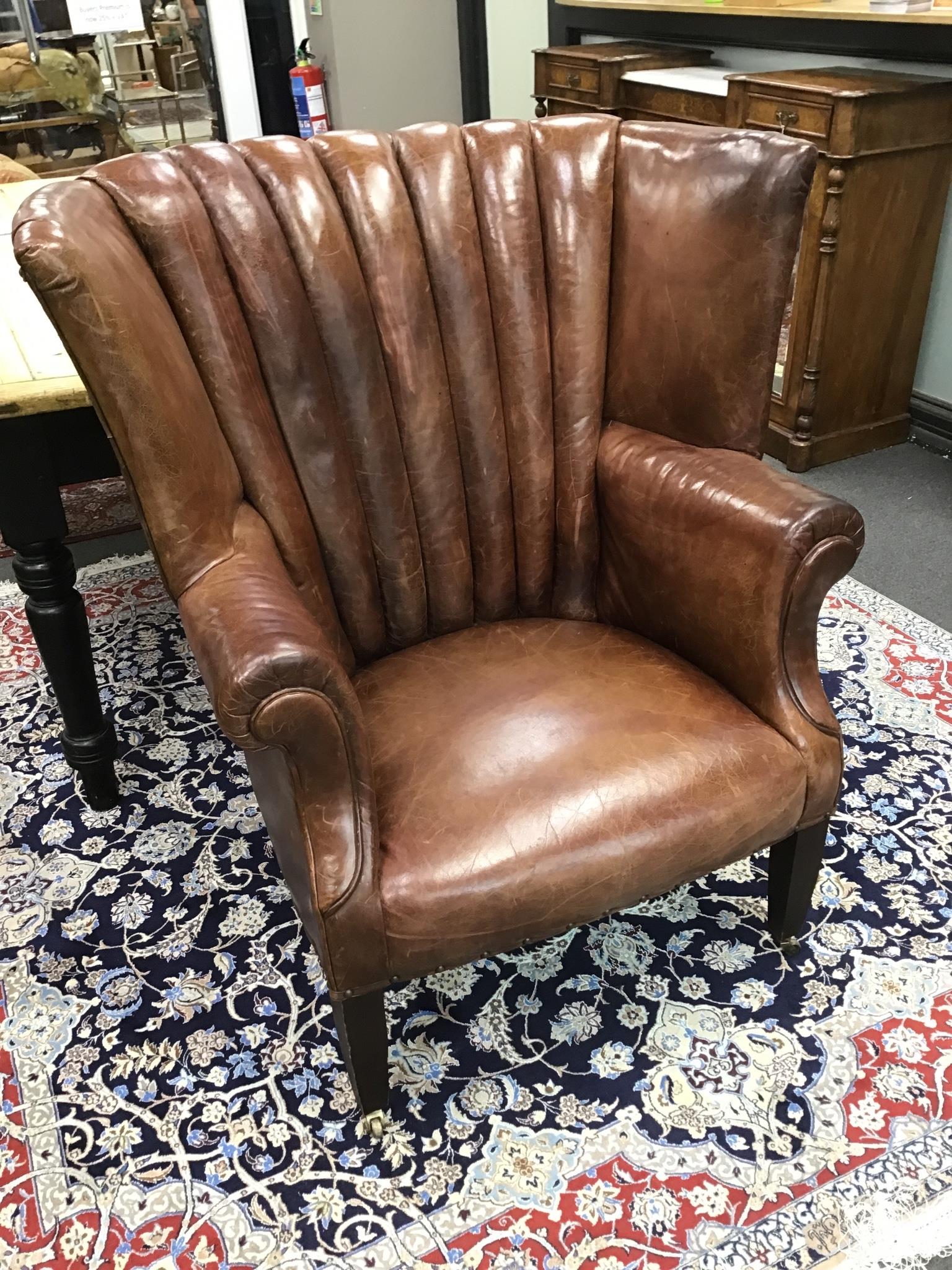 A Ralph Lauren brown leather tub framed library wing armchair on square tapered legs width 96cms, depth 76cms, height 107cms